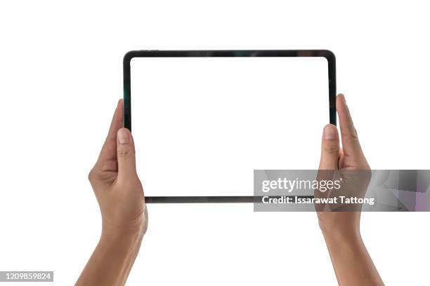 female hands holding a tablet computer gadget with isolated screen - tablet pc stockfoto's en -beelden