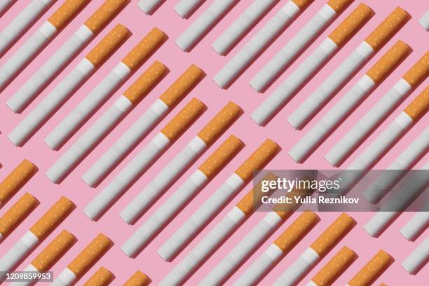 cigarettes on the pink background - sigaretta foto e immagini stock