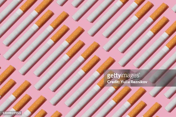 cigarettes on the pink background - smoking issues stock pictures, royalty-free photos & images