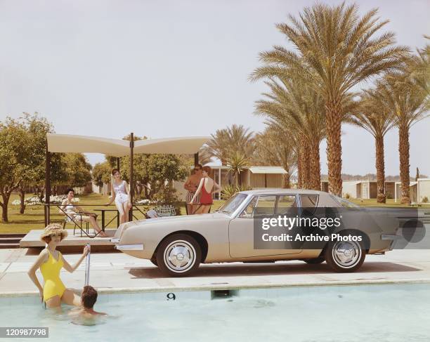 Studebaker Avanti by a swimming pool