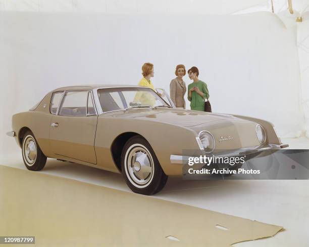 Friends standing beside a Studebaker Avanti