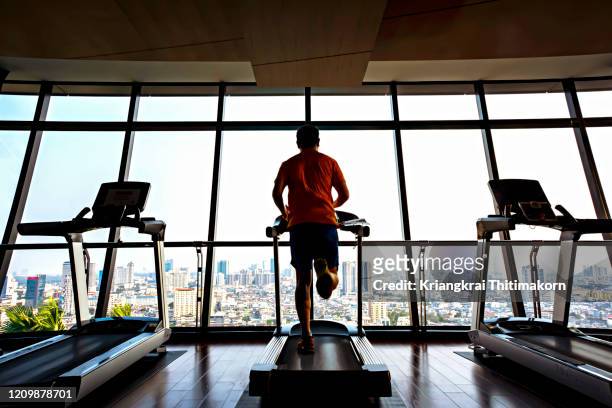 healthy lifestyle: jogging in the gym. - health club stock pictures, royalty-free photos & images