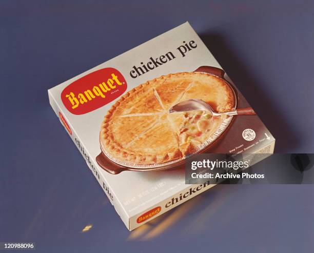 Carton of food product on blue background, close-up