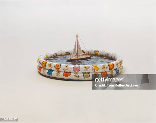 boat floating in paddling pool on white background - 1973 stock pictures, royalty-free photos & images