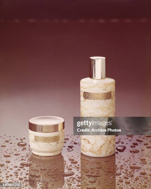 Moisturiser and spray bottle on brown background, close-up