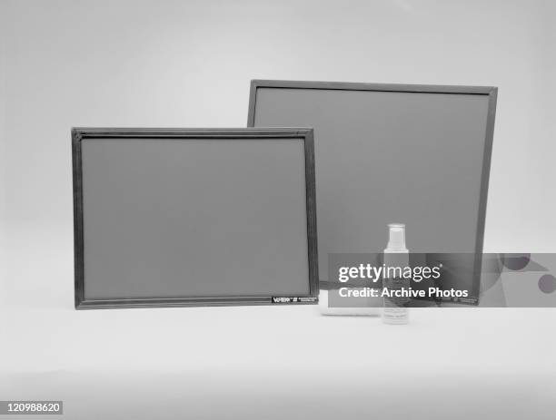 Picture frame and spray bottle on white background