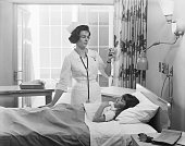 Female nurse checking girl's temperature