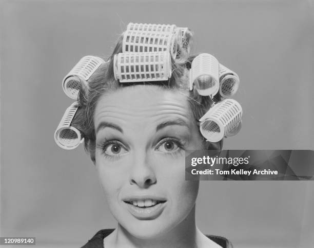 young woman in hair rollers, smiling, portrait - papiljott bildbanksfoton och bilder