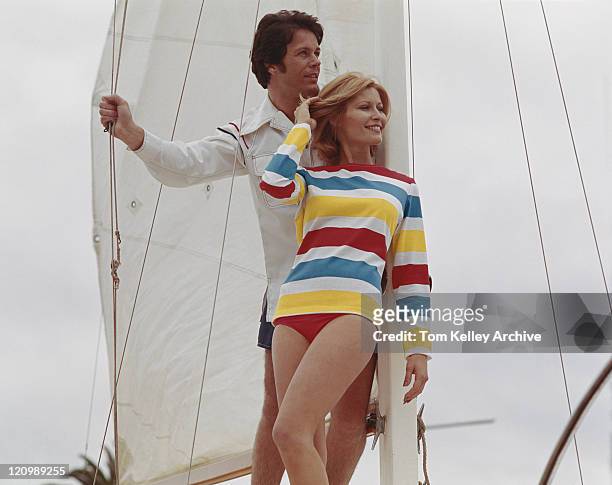 young couple leaning on mast - 1975 vacations stock pictures, royalty-free photos & images