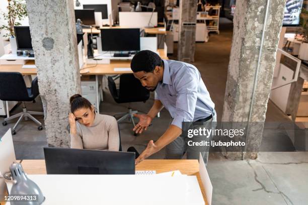 doubtful african hr talking to caucasian applicant at job interview - criticised stock pictures, royalty-free photos & images