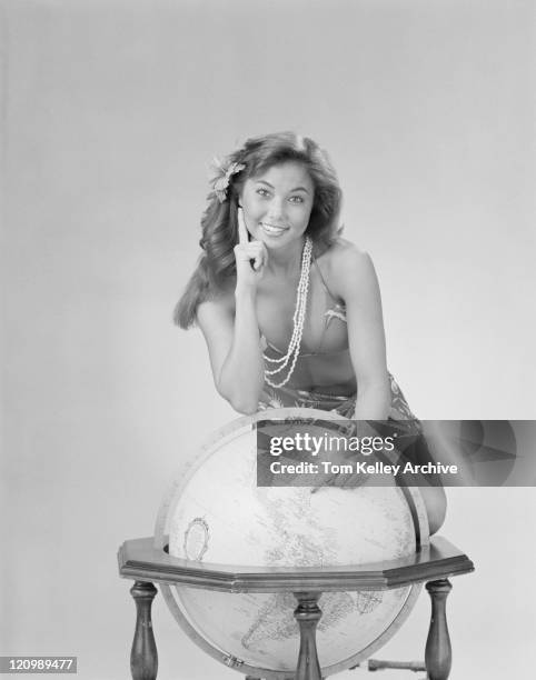 young woman pointing on globe, smiling, portrait  - 1982 stock pictures, royalty-free photos & images