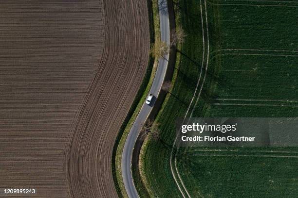 Car driving between field is pictured as aerial photograph on April 14, 2020 in Wiesa, Germany.