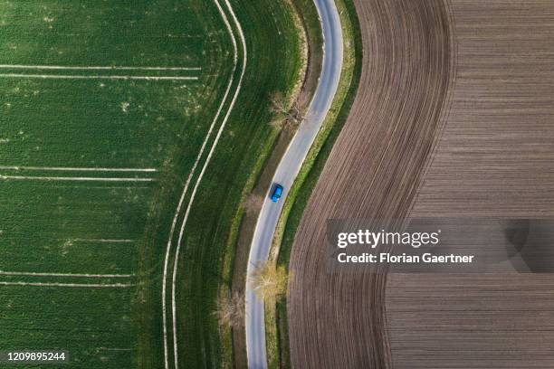 Car driving between field is pictured as aerial photograph on April 14, 2020 in Wiesa, Germany.