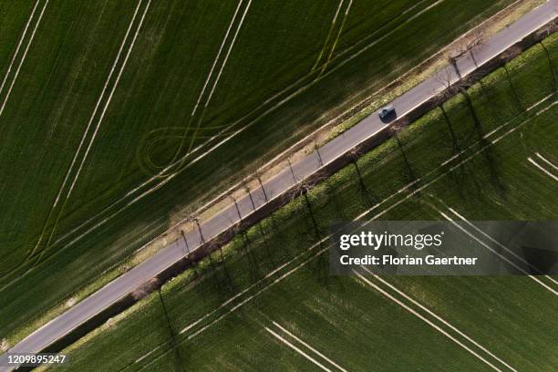 Car driving between field is pictured as aerial photograph on April 14, 2020 in Wiesa, Germany.