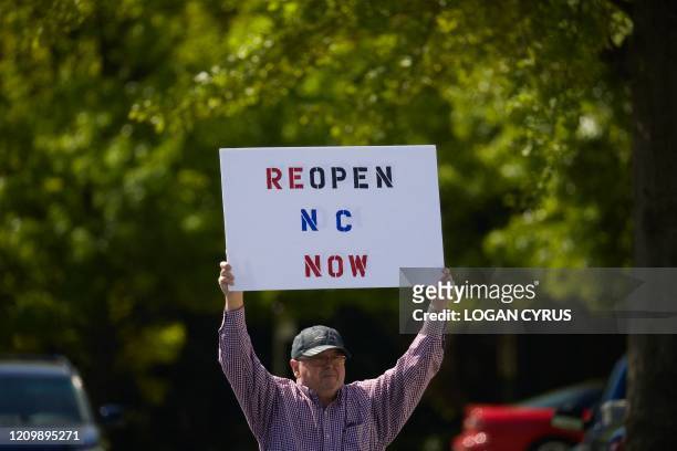 Protesters from a grassroots organization called "REOPEN NC" protests the North Carolina coronavirus lockdown at a parking lot adjacent to the North...