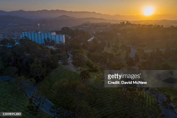 An aerial view shows Forest Lawn Memorial Park cemetery at sunrise as coronavirus infections accelerate on April 14, 2020 in Glendale, California....