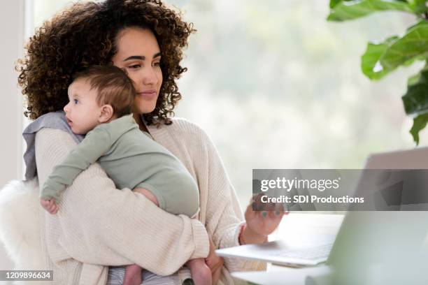 multi-tasking mom at work - mother and baby and laptop stock pictures, royalty-free photos & images