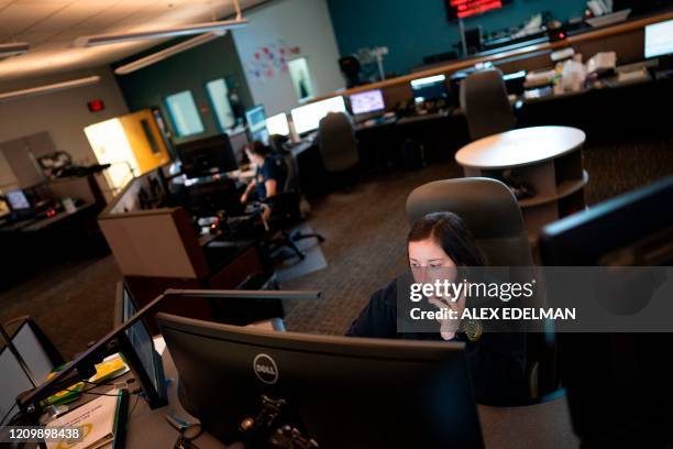 Dispatcher with Anne Arundel County Fire Department answers a 911 emergency call from their department dispatch center on April 14, 2020 in Glen...