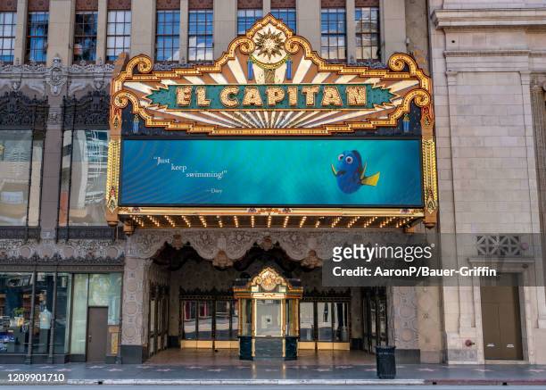 View of Disney's El Capitan Theatre with its updated marquee displaying inspiring messages from Disney characters like Dory, Peter Pan, Snow White...