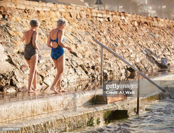 senior friends going for a swim - mature women swimming stock pictures, royalty-free photos & images