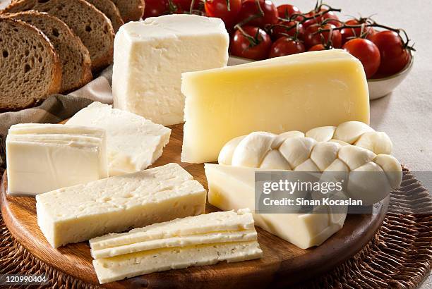 different types of cheese, bread and tomatoes - cheddar cheese board stock pictures, royalty-free photos & images