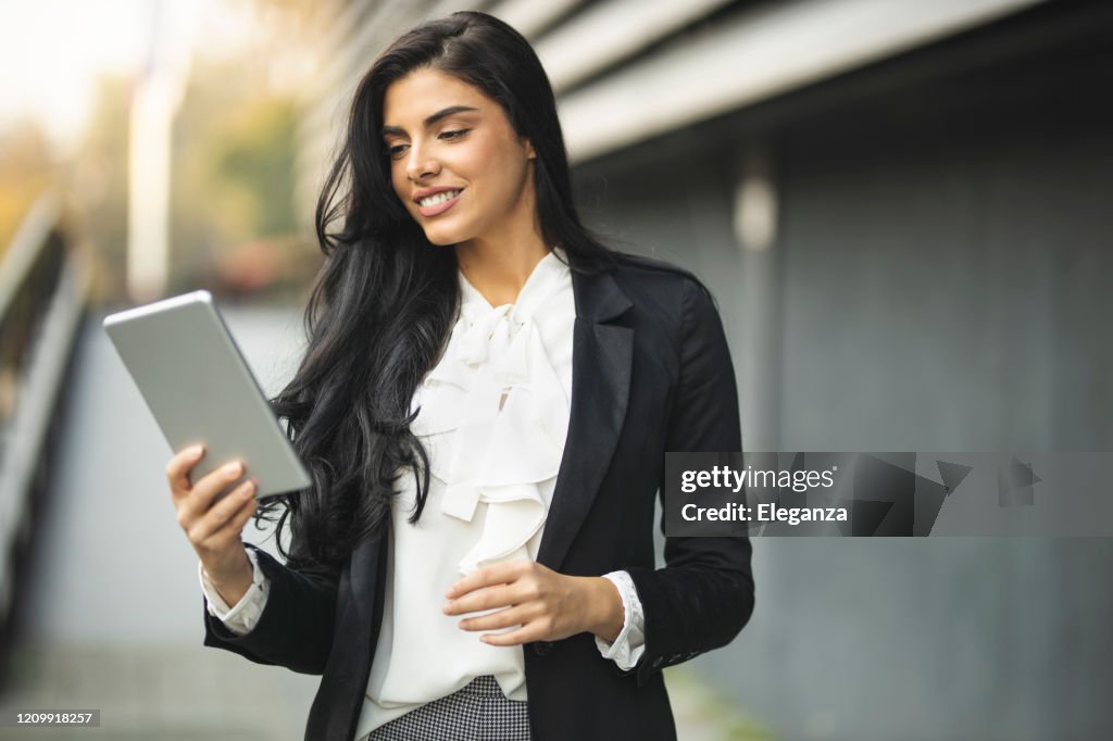 Portrait of businesswoman holding digital tablet