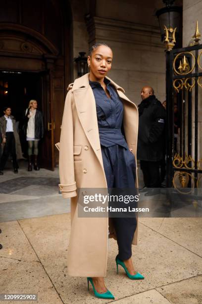 Naomi Ackie wearing Stella McCartney trench coat, navy shirt green stilettos and baby blue leather bag outside Stella McCartney during Paris Fashion...