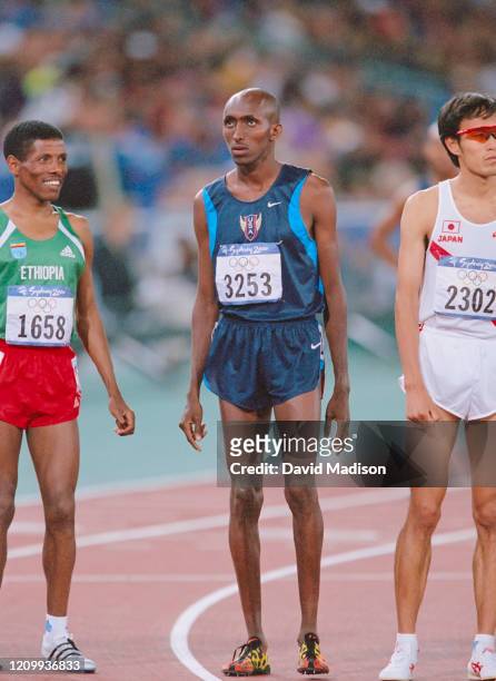 Haile Gebrselassie of Ethiopia, Abdi Abdirahman of the USA, and Katsuhiko Hanada of Japan line up at the start of the Men's 10000 meter Final of the...