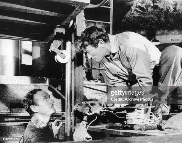 David Niven and Gregory Peck wiring location in a scene from the film 'The Guns Of Navarone', 1966.
