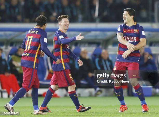 Luis Suarez is congratulated by Barcelona teammates Lionel Messi and Neymar after scoring a goal during the second half of the Club World Cup final...