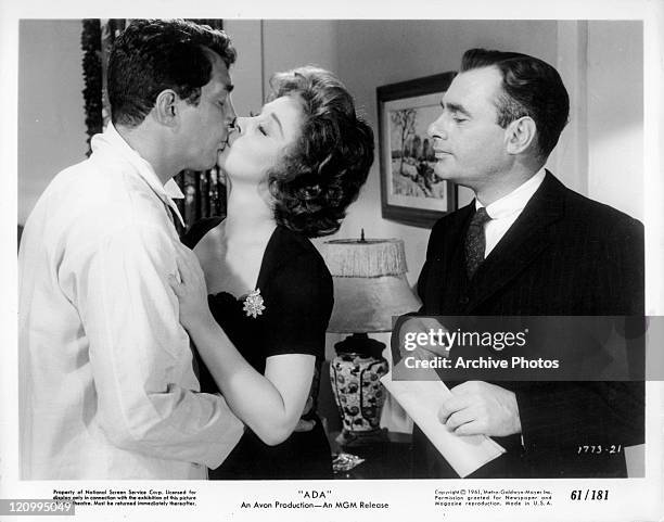 Dean Martin and Susan Hayward kiss in front of Martin Balsam in a scene from the film 'Ada', 1961.