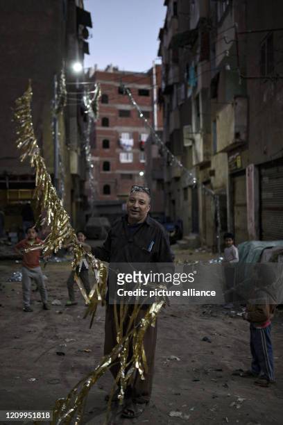 April 2020, Egypt, Menofia Governorate: A man take part in making Ramadan decorations which also know for Egyptians as at Shuhada village, as It is...