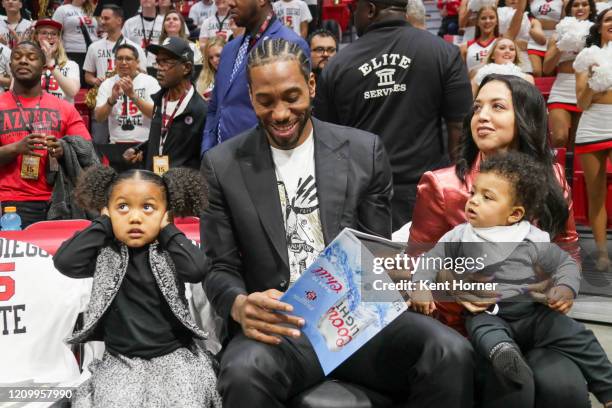 Alumni Kawhi Leonard of the San Diego State Aztecs and NBA fame walks onto the court and sits with his family during the first half of the game...