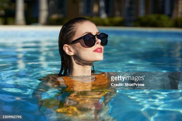 the girl looks at the sun and rejoices, bathes in cool clear water - hyatt hotels corp hotel ahead of earnings figures stockfoto's en -beelden