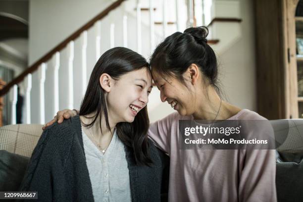 mother and teenage daughter talking at home - asian teenager fotografías e imágenes de stock