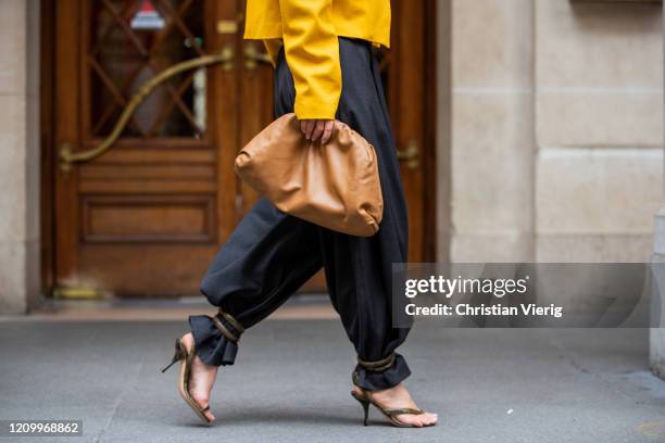 Gitta Banko is seen wearing yellow short blazer with shoulder pad by Liviana Conti, dark grey high waist belted stripe Pants by Balossa, sandals with...
