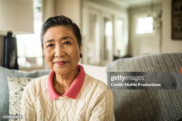 portrait of senior woman at home - chinese people posing for camera fotografías e imágenes de stock