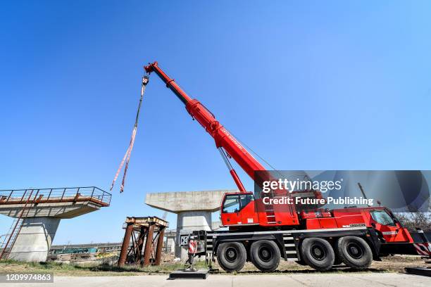 Mobile crane is pictured at the construction site of the new bridge across the Dnipro River in Zaporizhzhia, southeastern Ukraine. - PHOTOGRAPH BY...