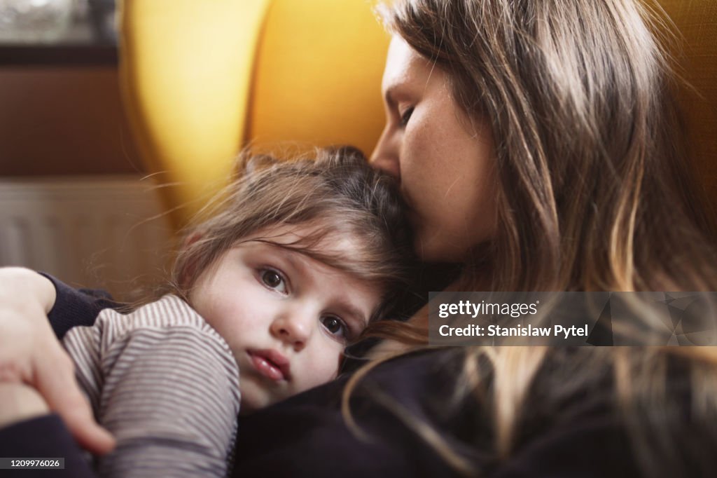 Mother hugs sad daughter