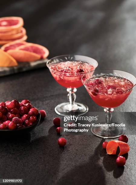 cranberry grapefruit martinis - cocktail and mocktail stock pictures, royalty-free photos & images