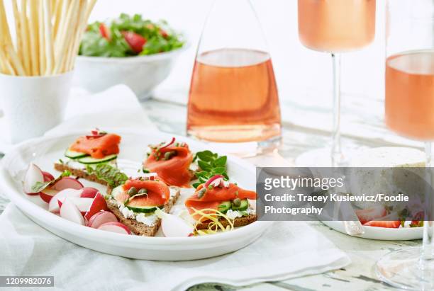 smoked salmon canapes with rose wine - al fresco dining stock pictures, royalty-free photos & images