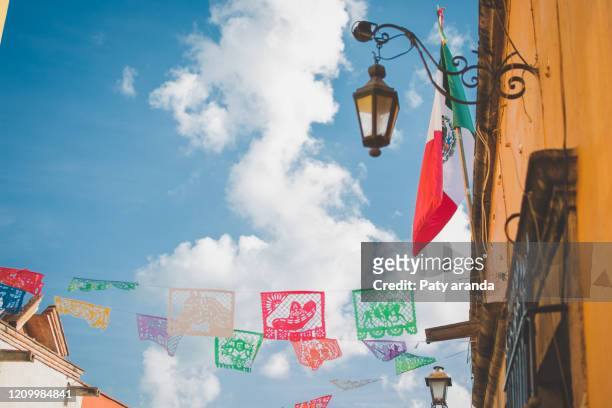 beautiful colored strings of papel picado in san miguel de allende, gto. with mexican decoration. september 2019 - mexico independence stock pictures, royalty-free photos & images