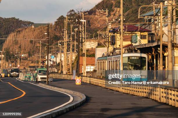 local train running by the sea in kanagawa prefecture of japan - kamakura stock-fotos und bilder