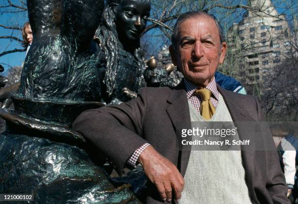 American publisher George T. Delacorte, Jr. In New York's Central Park, 1982. He is standing in front of Jose de Creeft's statue of 'Alice in...