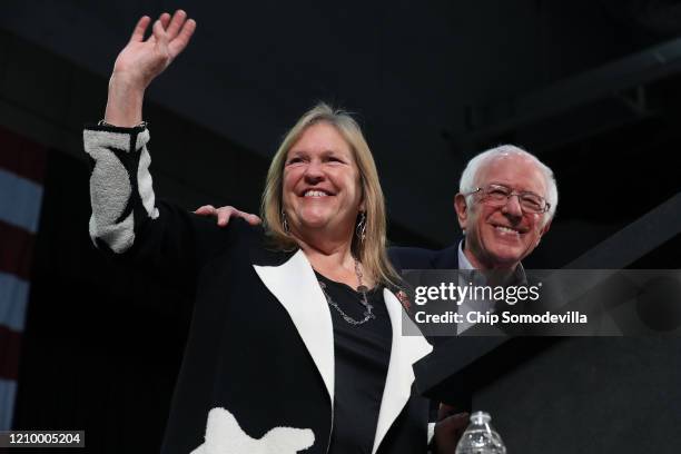 Democratic presidential candidate Sen. Bernie Sanders and his wife Jane O'Meara Sanders take the stage during a campaign rally at the Roy Wilkins...