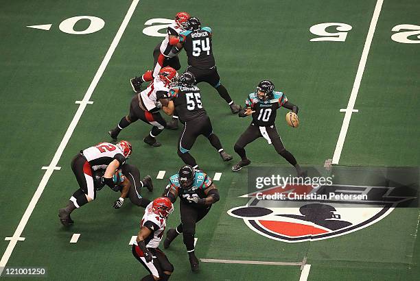 Quarterback Nick Davila of the Arizona Rattlers drops back to pass against the Jacksonville Sharks during the ArenaBowl XXIV at US Airways Center on...