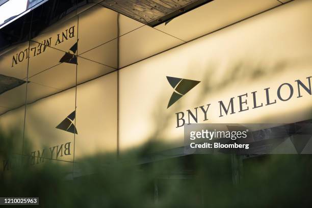Signage is displayed outside a Bank of New York Mellon Corp. Office building in New York York, U.S., on Saturday, April 11, 2020. Bank Of New York...