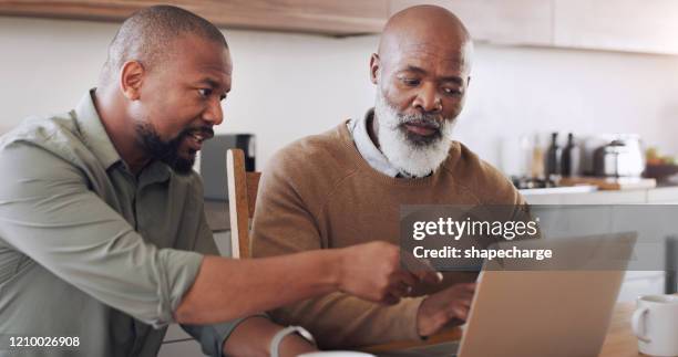 let me show you what to do - african american father and son stock pictures, royalty-free photos & images