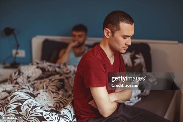 gay couple having problems and conflict at home - sad gay person stock pictures, royalty-free photos & images