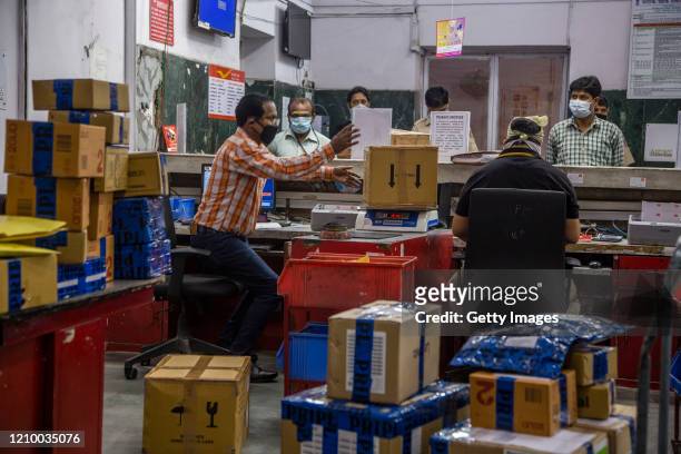 Indians are being attended by employees at General Post Office while they are being helped to deliver lifesaving medicines, as India remains under an...